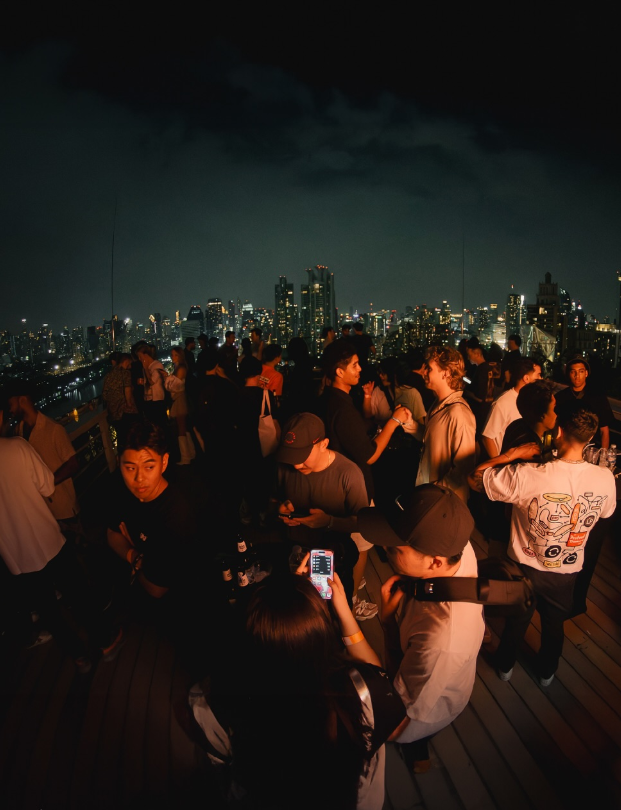 The AMBER rooftop terrace at night above the lit Bangkok skyline