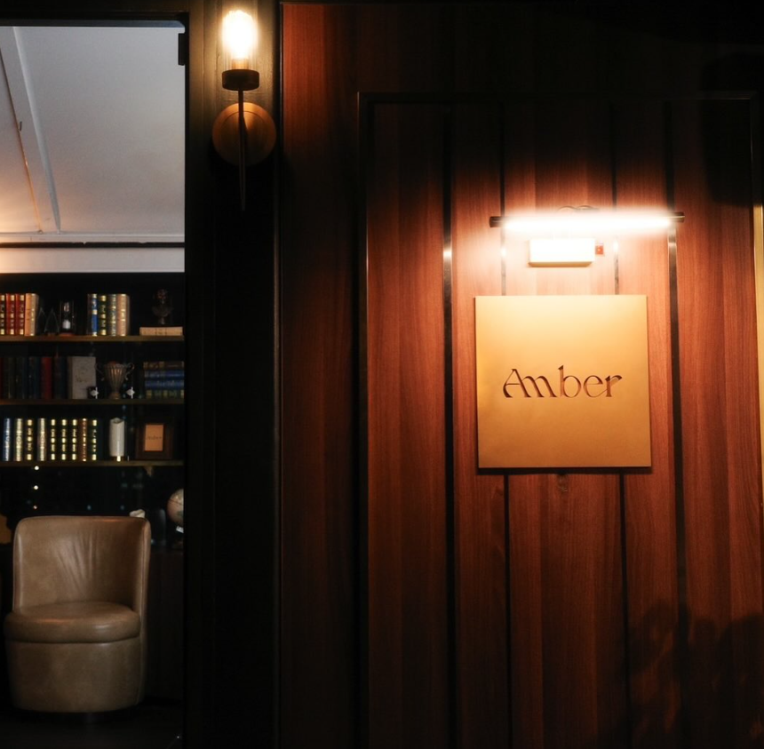 The brass AMBER plaque at the entrance to the rooftop bar